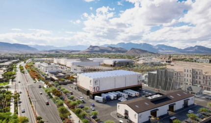 A rendered image of the proposed Summerlin Production Studios in Las Vegas, showcasing multiple soundstages, backlots, and production facilities with a scenic mountain backdrop and nearby residential areas.